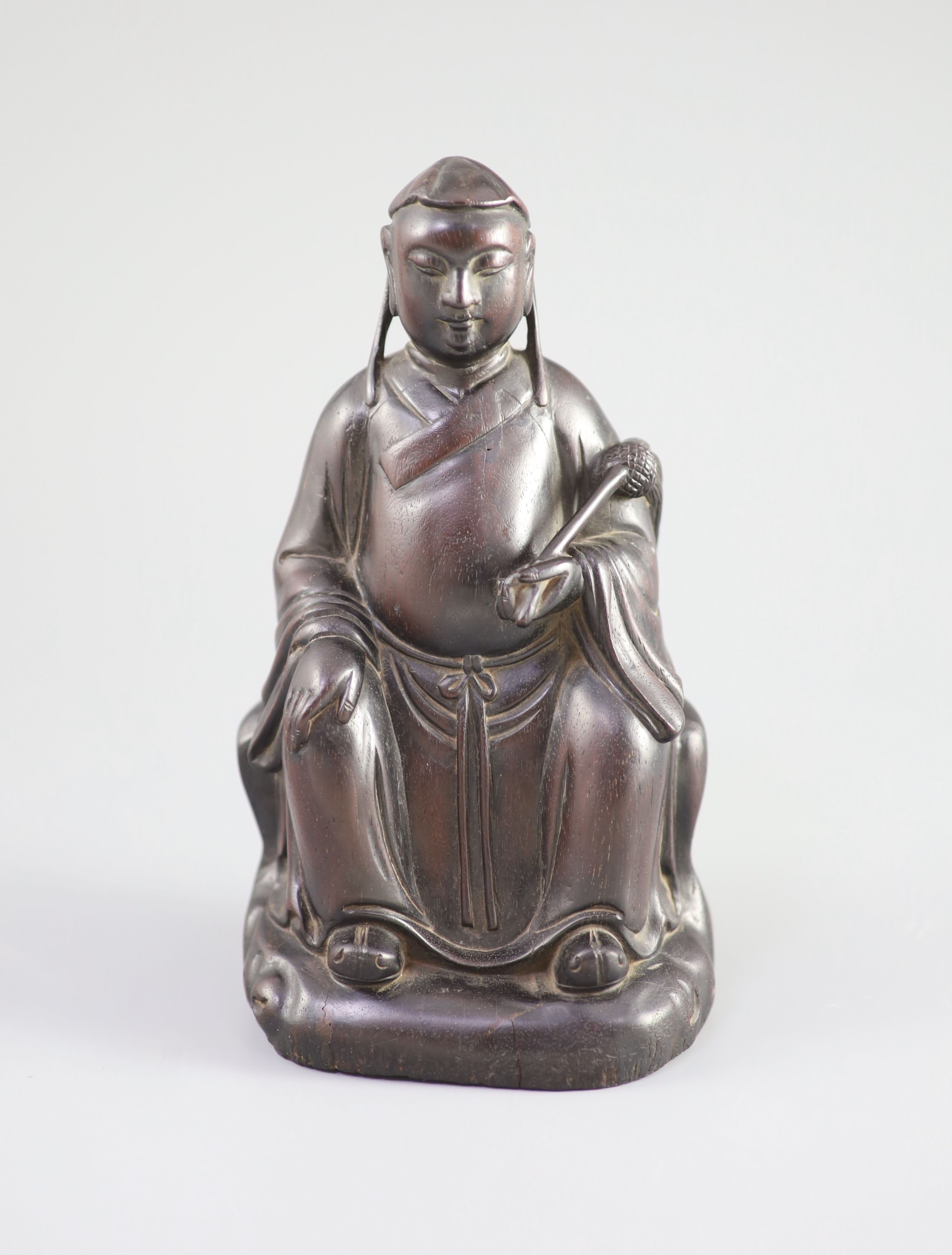 A Chinese Zitan seated figure of an official, 18th century, 19.3cm high